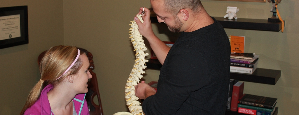 Dr. Trimner explaining the spine to a client